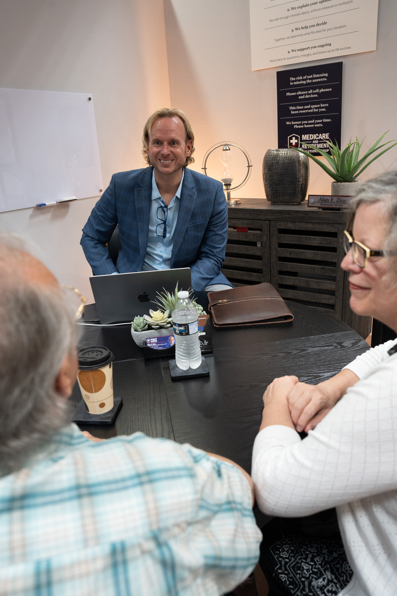 Friendly Medicare agent having a confidential conversation with clients in Beavercreek, Ohio